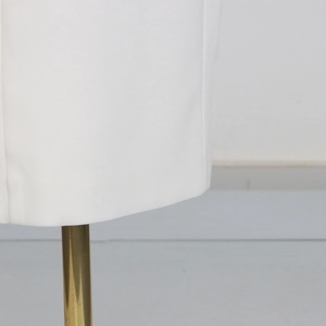 Detailed close-up of white fabric texture on a gold stand showing the premium drape quality