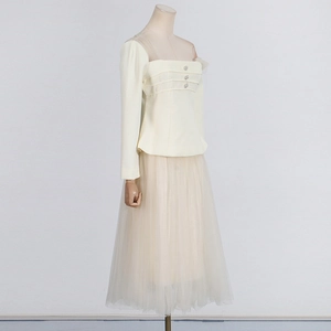 Detail view of square neck mesh top with rhinestone buttons and a layered tulle midi skirt