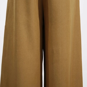 Detail shot of brown wide-leg jumpsuit showing fabric texture and tailored crotch seam