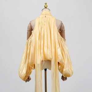 Close-up of yellow pleated halter neck top with lantern sleeves and silky finish
