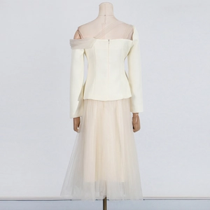 Rear view detail of the elegant beige mesh patchwork top and high-waist midi skirt set
