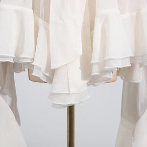 Detail of layered white mesh ruffles with fine overlock edge on elegant chiffon blouse