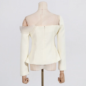 Detail of off-white long sleeve top with mesh patchwork and asymmetric neckline