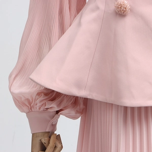 Detail of pink pleated top featuring exquisite beaded flowers and lantern sleeve cuff