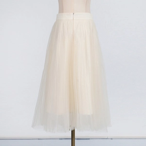 Detail of high-waist tiered tulle skirt with invisible back zipper in apricot beige
