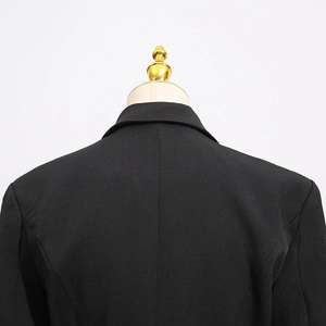 Detailed view of the back collar and shoulder stitching on a slim black bow blazer
