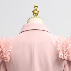 Detail of light pink summer set featuring pleated ruffle edges and high-quality fabric