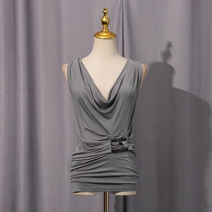 Detail of grey cowl neck tank top featuring side pleats and decorative silver patch