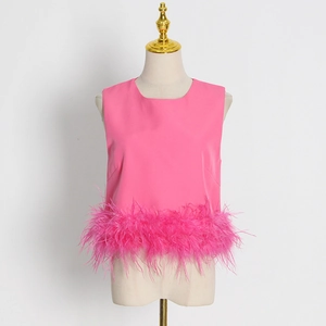 Detail of rose pink sleeveless top featuring lush ostrich feather trim at the bottom hem