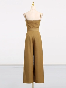 Mustard yellow jumpsuit with thin straps and waist belt, back view with hidden zipper