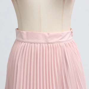 Detail of pink pleated chiffon skirt featuring high waist design and hidden side zipper