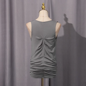 Detail of grey sleeveless top showing pleated back design on a mannequin stand