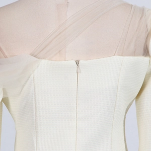Detail of invisible zipper and mesh stitching on ivory tweed square neck top back