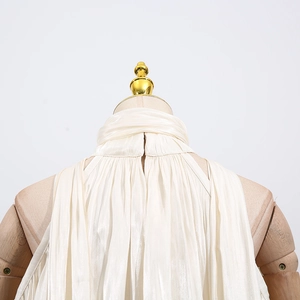 Close-up of pleated halter neck back detail on a cream sleeveless top with fine texture