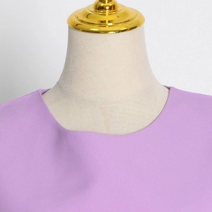 Close-up of lavender crewneck top with premium fabric texture on beige mannequin