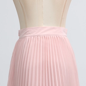 Detail of light pink pleated skirt waistline showing invisible side zipper on a mannequin