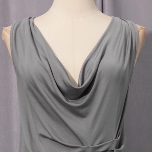 Macro detail of elegant grey cowl neck sleeveless top showing soft pleated fabric texture