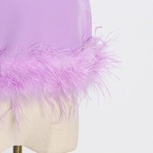Detail of lavender top featuring delicate ostrich feather trim at the bottom hemline