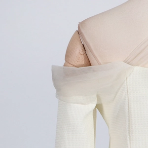 Detail of square neck top with ivory mesh patchwork and woven tweed fabric texture
