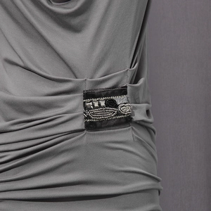 Close-up of grey vintage top featuring intricate beadwork and crystal embellishments