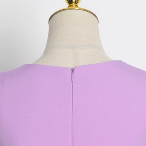 Close-up of a lavender top showing the smooth invisible back zipper and textured fabric