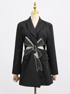 Slim fit black blazer dress featuring side cut-outs and a large rhinestone bow detail