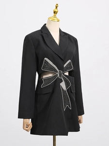 Slim fit black blazer dress with waist cutout and sparkling rhinestone bow detail