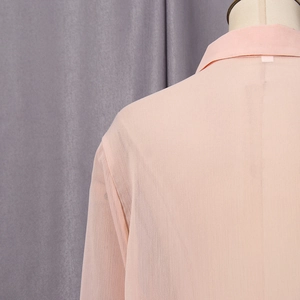 Close-up of light pink chiffon shirt showing fabric texture and elegant collar details