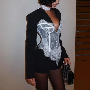 Detail of slim-fit blazer featuring contrast lace corset panels and button closure
