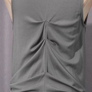 Detailed close-up of dark gray sleeveless top with pleated back stitching design