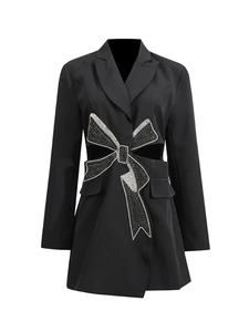 Slim black blazer dress featuring cutout waist and large rhinestone bow decoration