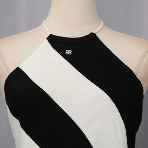 Detail of knit halter top with black and white stripes and metal logo hardware