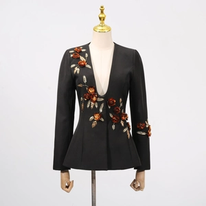 Detail of 3D floral embroidery and metallic leaf design on black women's blazer