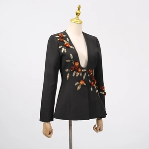 Close-up of handmade 3D floral embroidery on a black tailored blazer for women