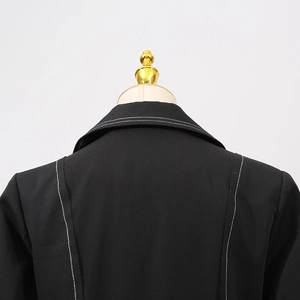 Detail of premium black trench coat featuring white contrast stitching on shoulder and collar