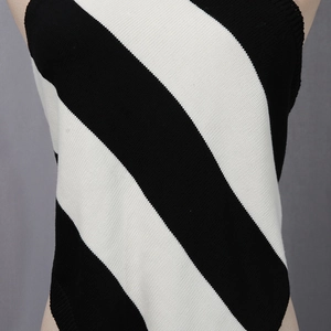 Close-up of black and white diagonal striped knit top showing fabric texture and detail