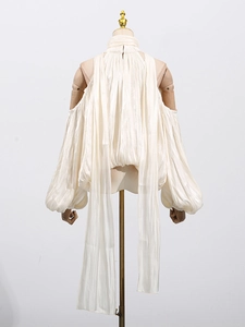 Elegant ivory halter-neck blouse with off-shoulder lantern sleeves and pleated texture