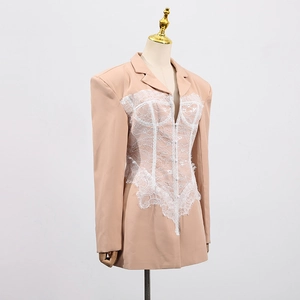 Detail of beige blazer dress with white lace patchwork and retro corset silhouette