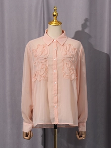 Elegant pale pink chiffon blouse with long sleeves and floral ruffles on the front
