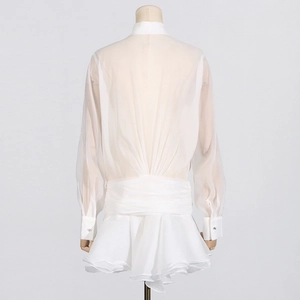 Rear view of white chiffon mini dress featuring long sleeves and tiered ruffle skirt detail