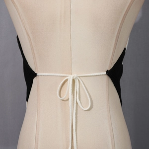 Detail view of the backless tie-up design with black and white knit striped patterns