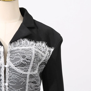 Detail of classic black blazer with white lace patchwork and eyelash fringe trim