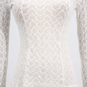 Close-up of white lace mesh fabric with geometric texture on a slim-fit knit top