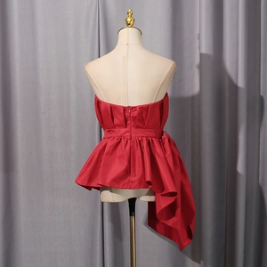 Rear view of red strapless top with ruffled hem and concealed back zipper detail