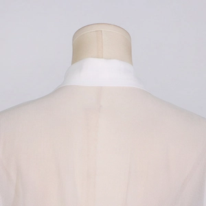 Detail shot of the back collar on a white mesh shirt with delicate sheer fabric texture