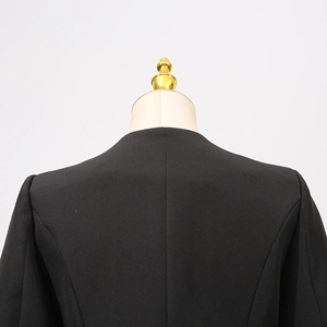 Detail of the collarless neckline and structured shoulders on this black blazer