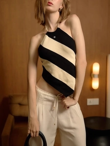 Chic striped halter knit top in black and beige paired with high-waist casual trousers