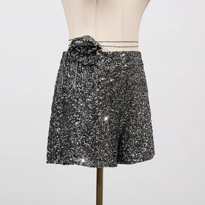 Detail der Pailletten-Shorts mit großer Zierblume und Metall-Taillenkette für Damen