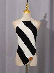 Women halter knit vest with diagonal black and white stripes and asymmetrical hem