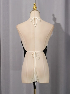 Sleeveless backless halter top for women featuring black and white contrast tie straps